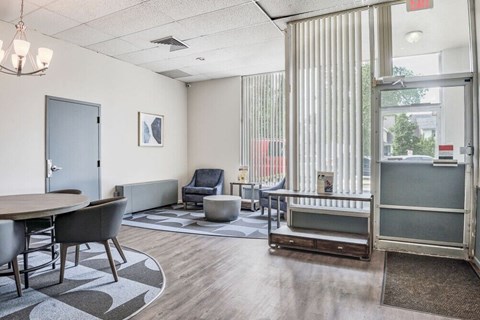 a living room with a table and chairs and a glass door